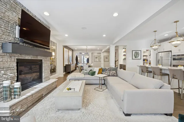 a living room with furniture flat screen tv and a fireplace