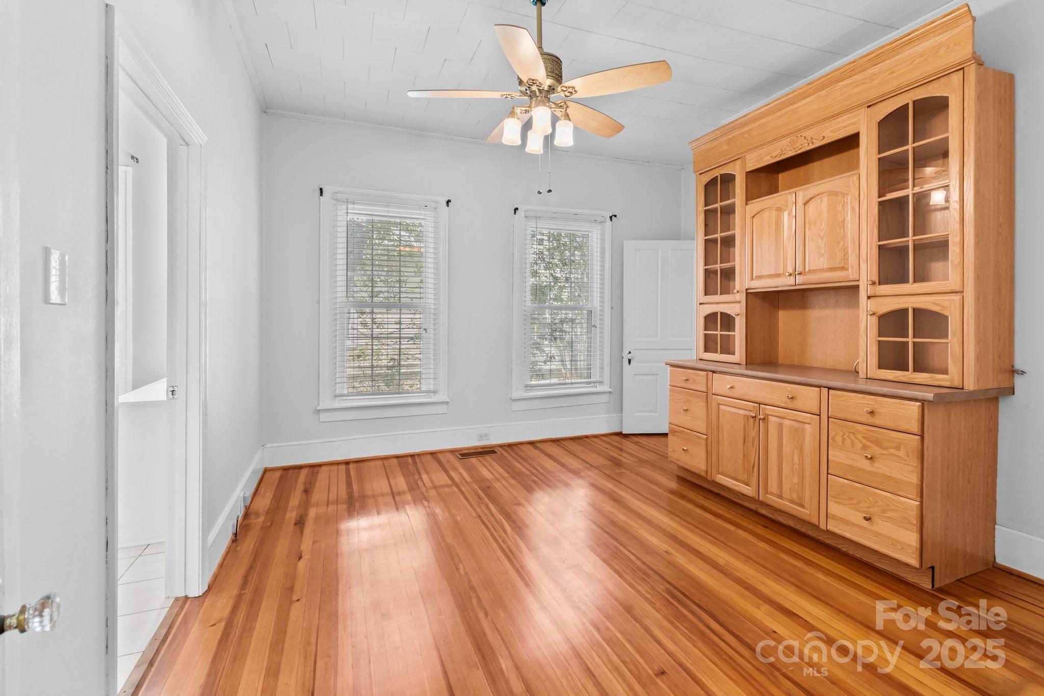 405 7th Street Spencer, NC 28159 - Photo 12 of 39 a view of an empty room with a window and wooden floor