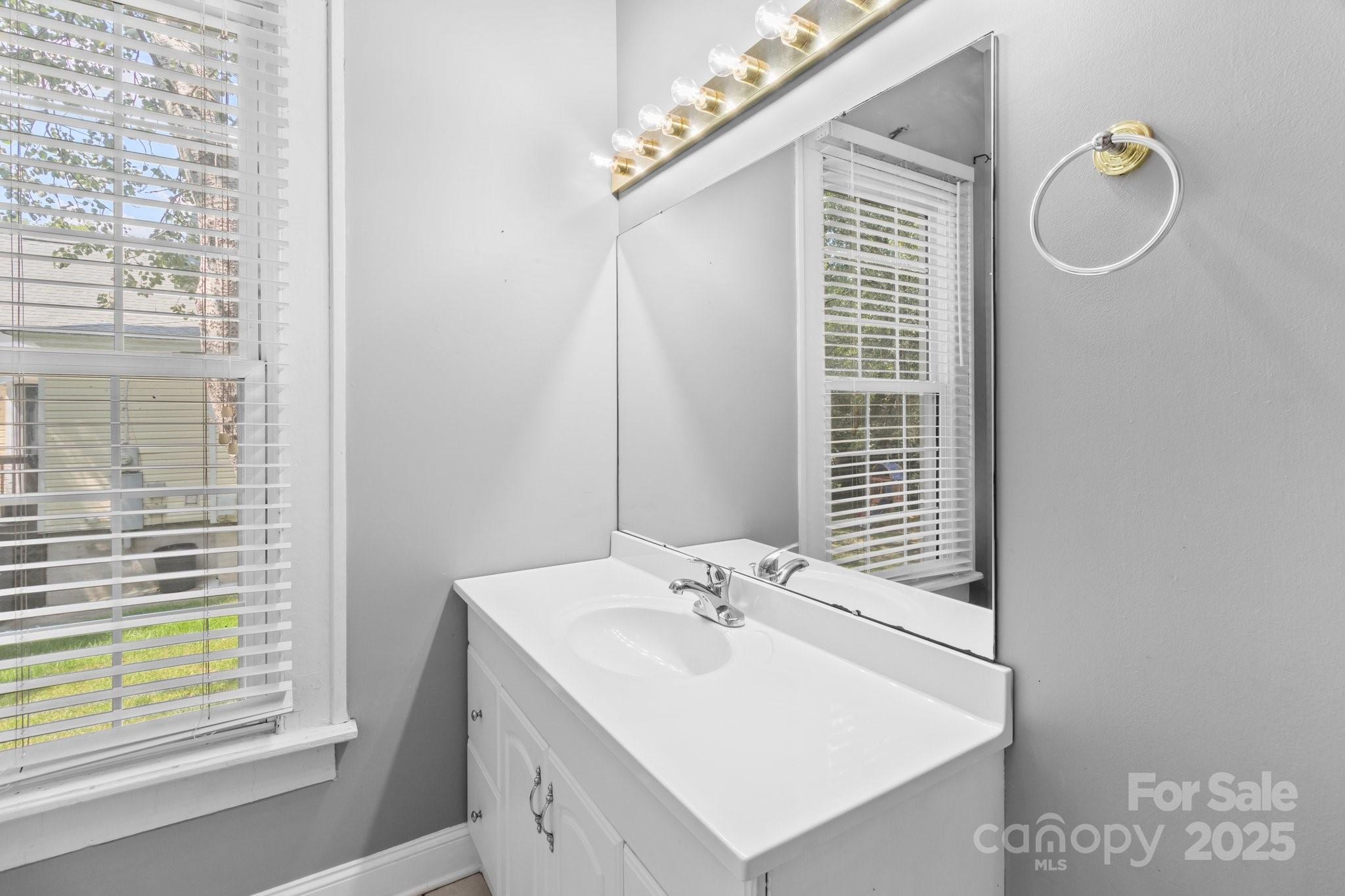 405 7th Street Spencer, NC 28159 - Photo 24 of 39 a bathroom with a sink vanity and a mirror