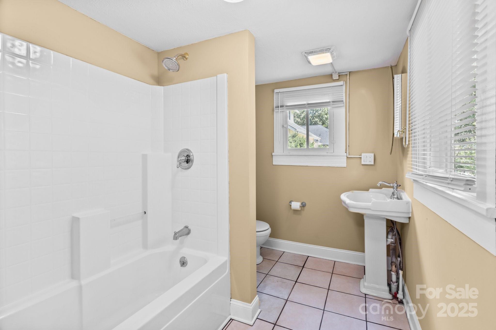 405 7th Street Spencer, NC 28159 - Photo 6 of 39 a bathroom with a bathtub and a sink