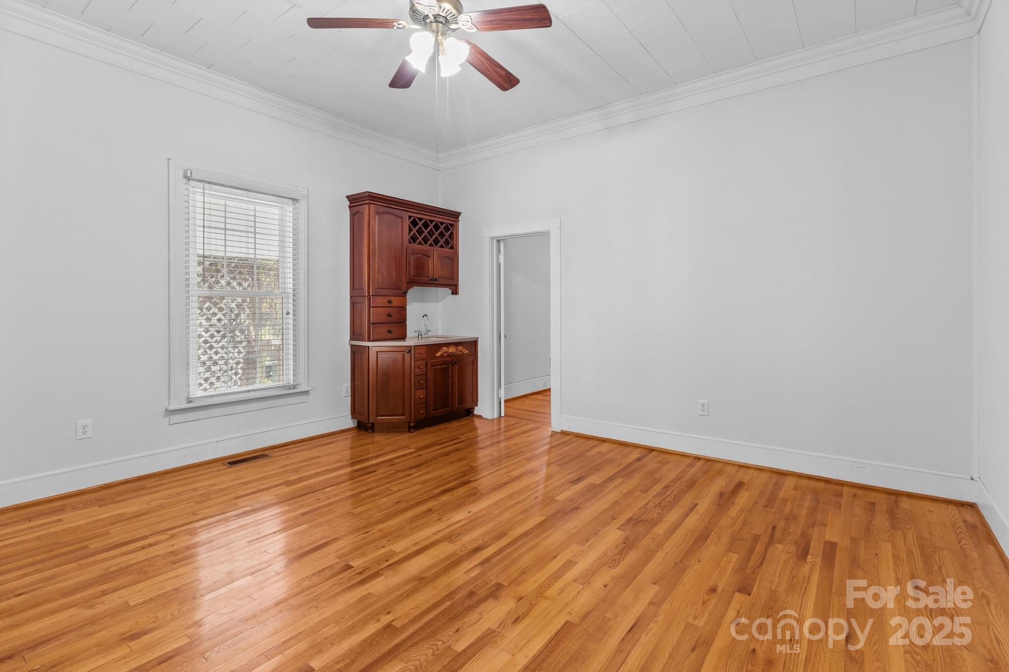 405 7th Street Spencer, NC 28159 - Photo 8 of 39 a view of an empty room with wooden floor and a window