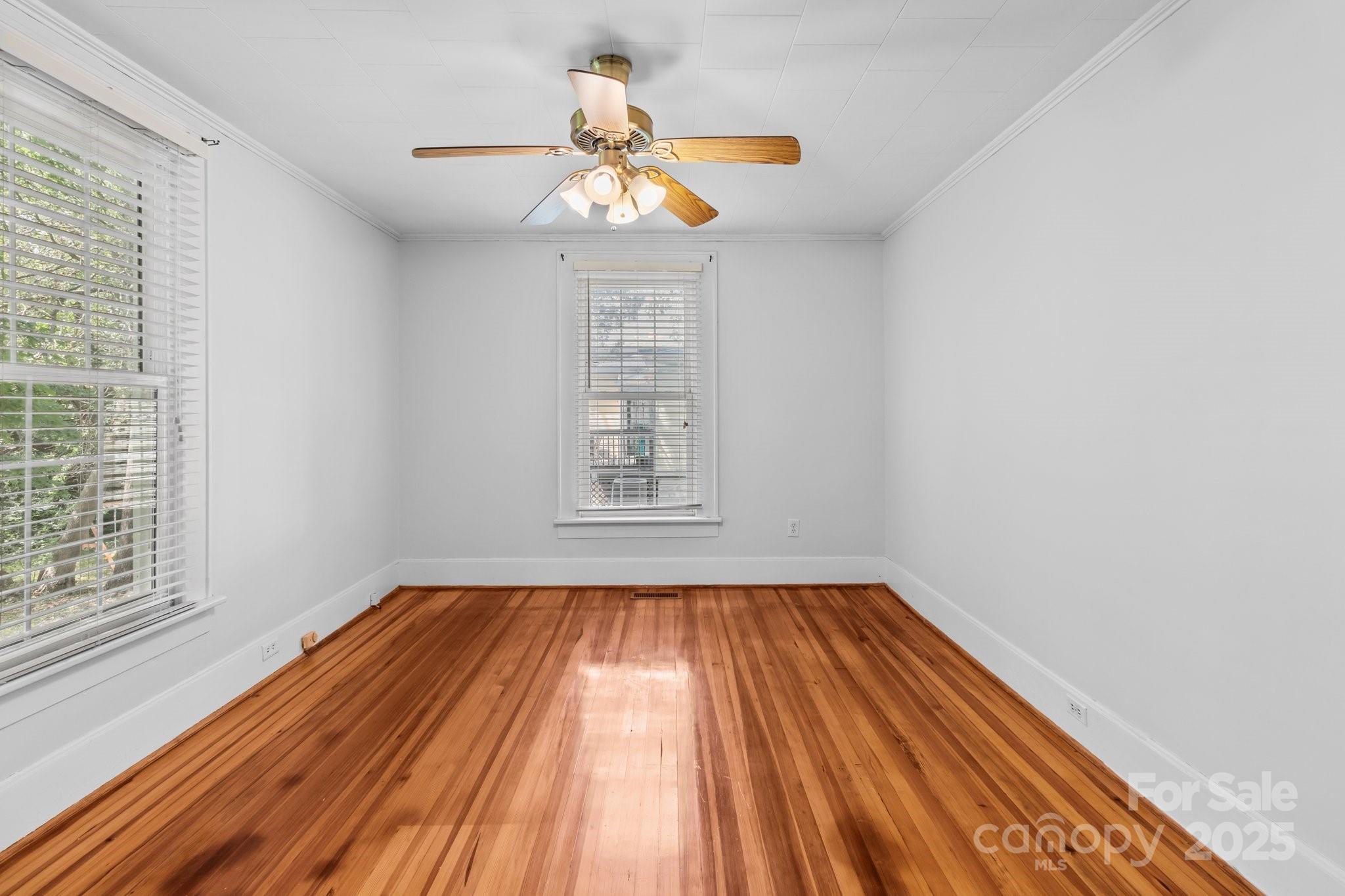 405 7th Street Spencer, NC 28159 - Photo 9 of 39 a view of empty room with wooden floor and fan