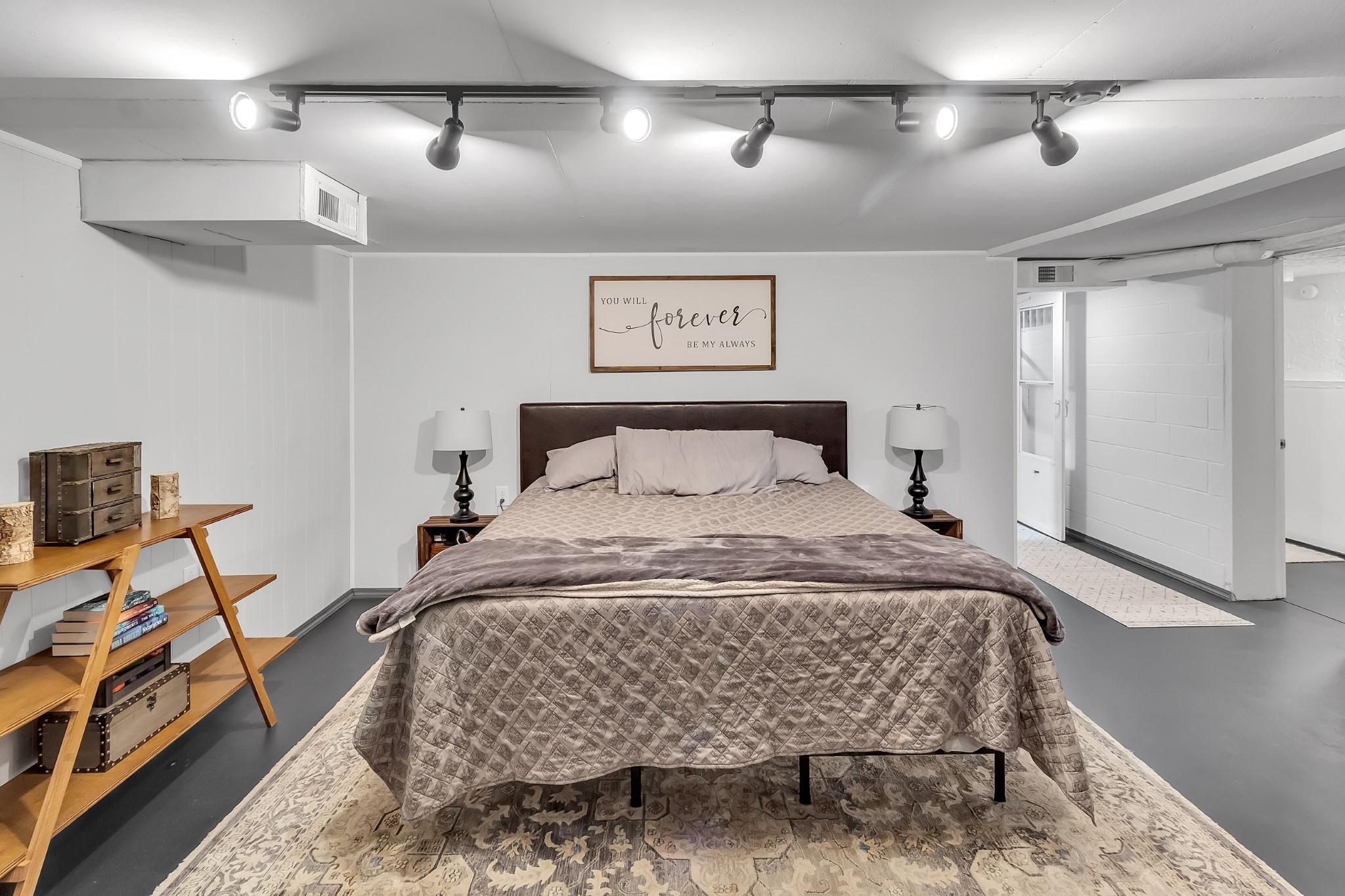 670 Thompson Cove Road Clyde, NC 28721 - Photo 14 of 45 a bedroom with a bed and a chandelier