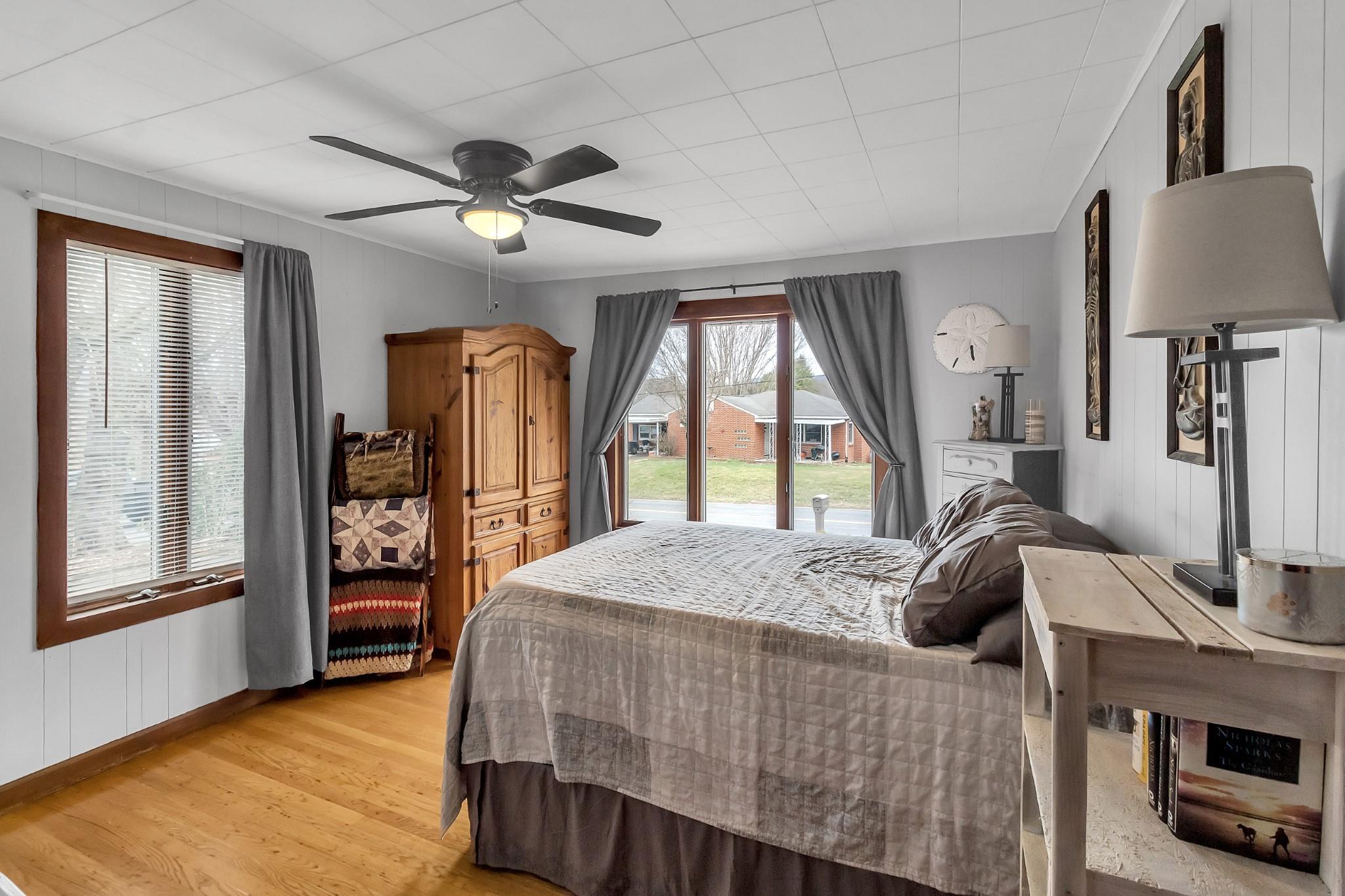 670 Thompson Cove Road Clyde, NC 28721 - Photo 22 of 45 a living room with a bed furniture and a large window