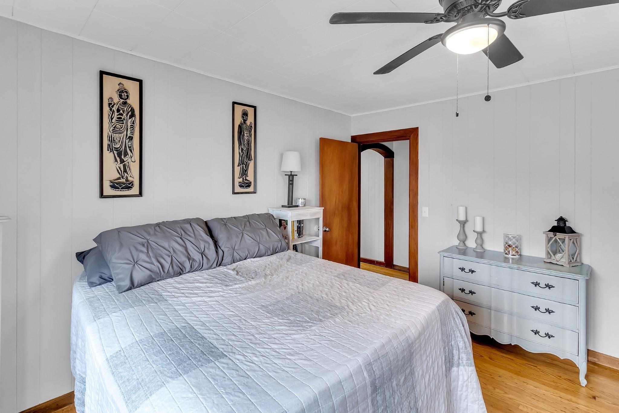 670 Thompson Cove Road Clyde, NC 28721 - Photo 24 of 45 a bedroom with a large bed and a chandelier