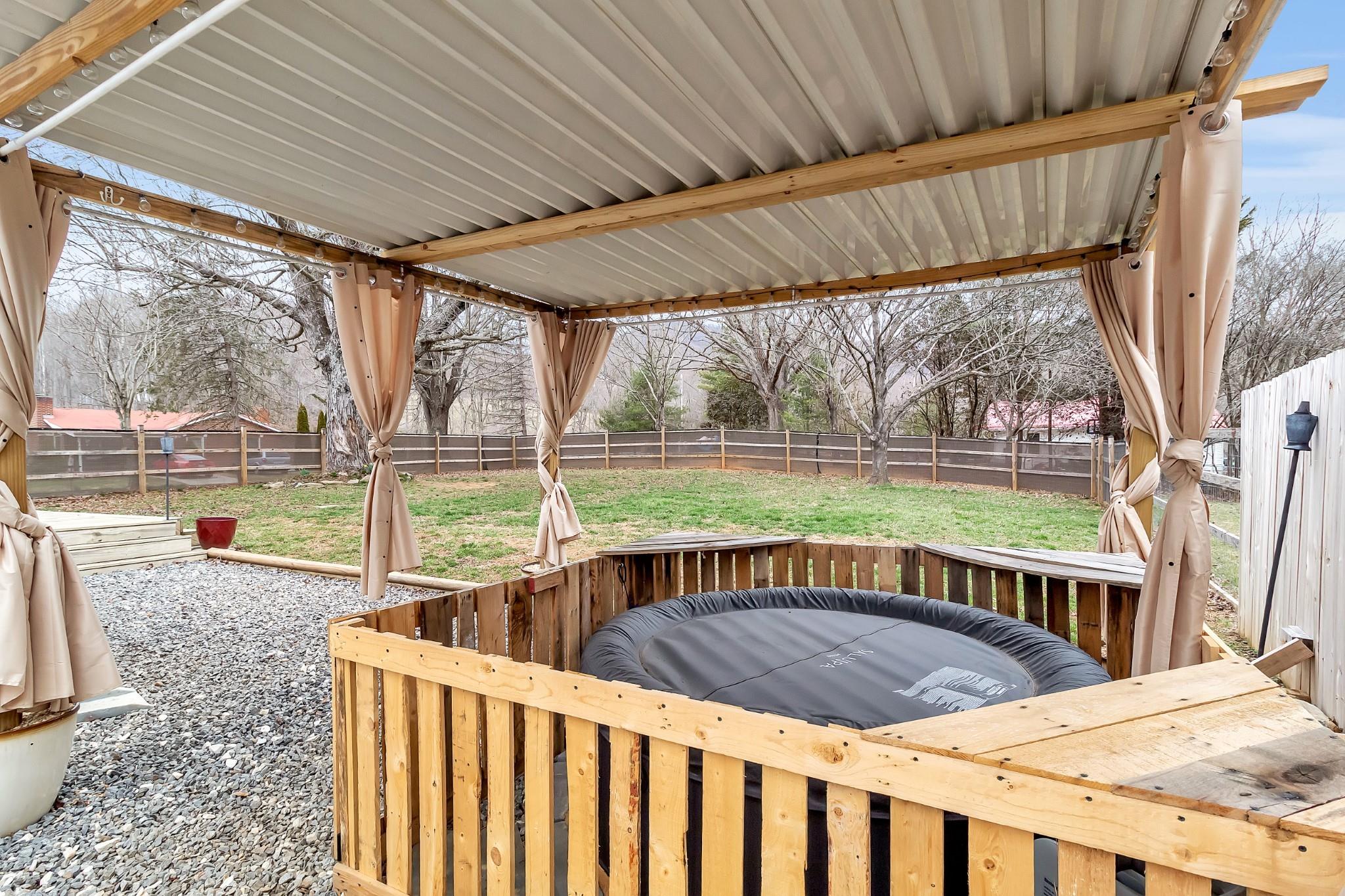 670 Thompson Cove Road Clyde, NC 28721 - Photo 34 of 45 a view of backyard with a deck and hardwood