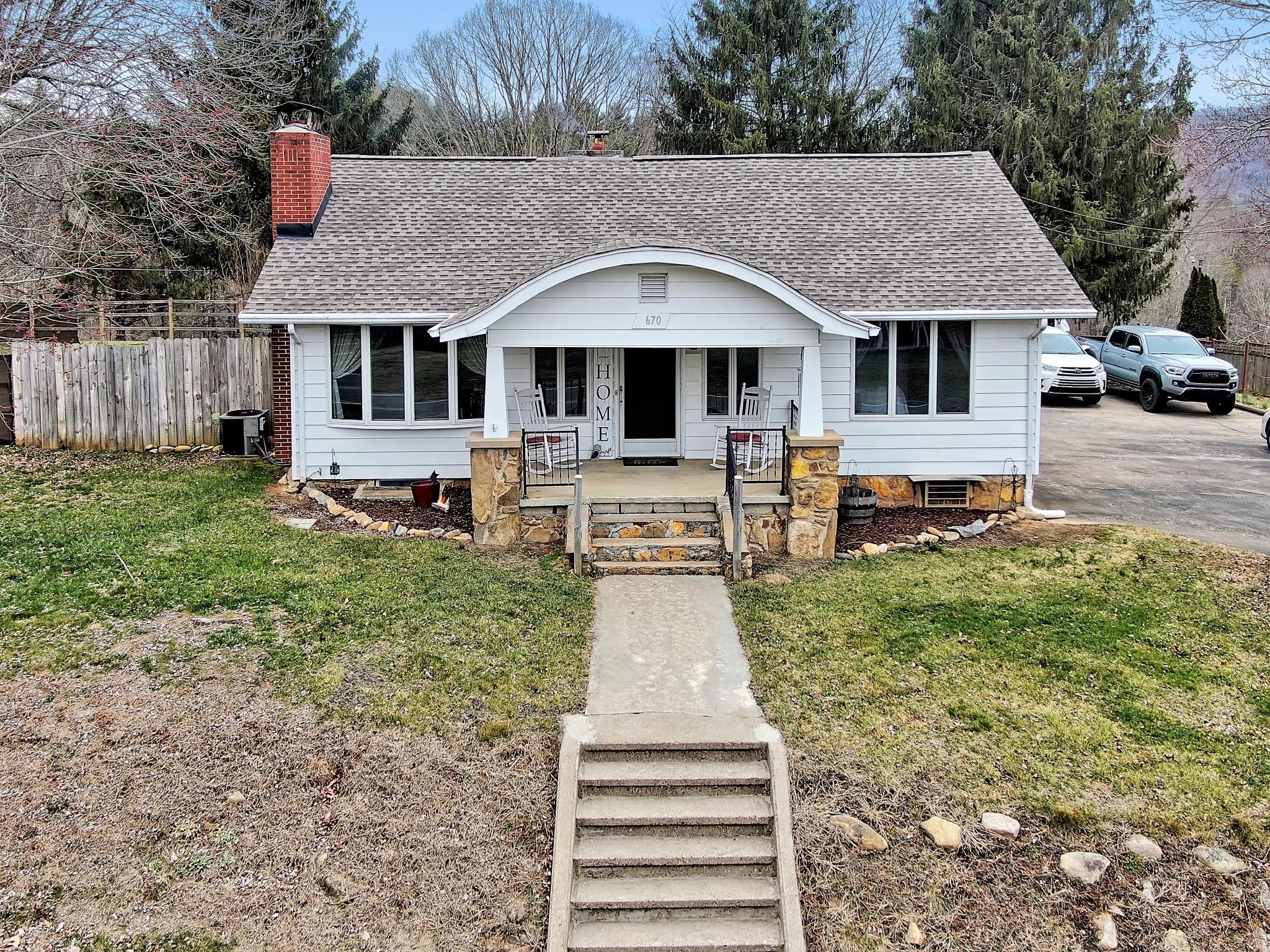 670 Thompson Cove Road Clyde, NC 28721 - Photo 41 of 45 a front view of a house with a yard patio and fire pit