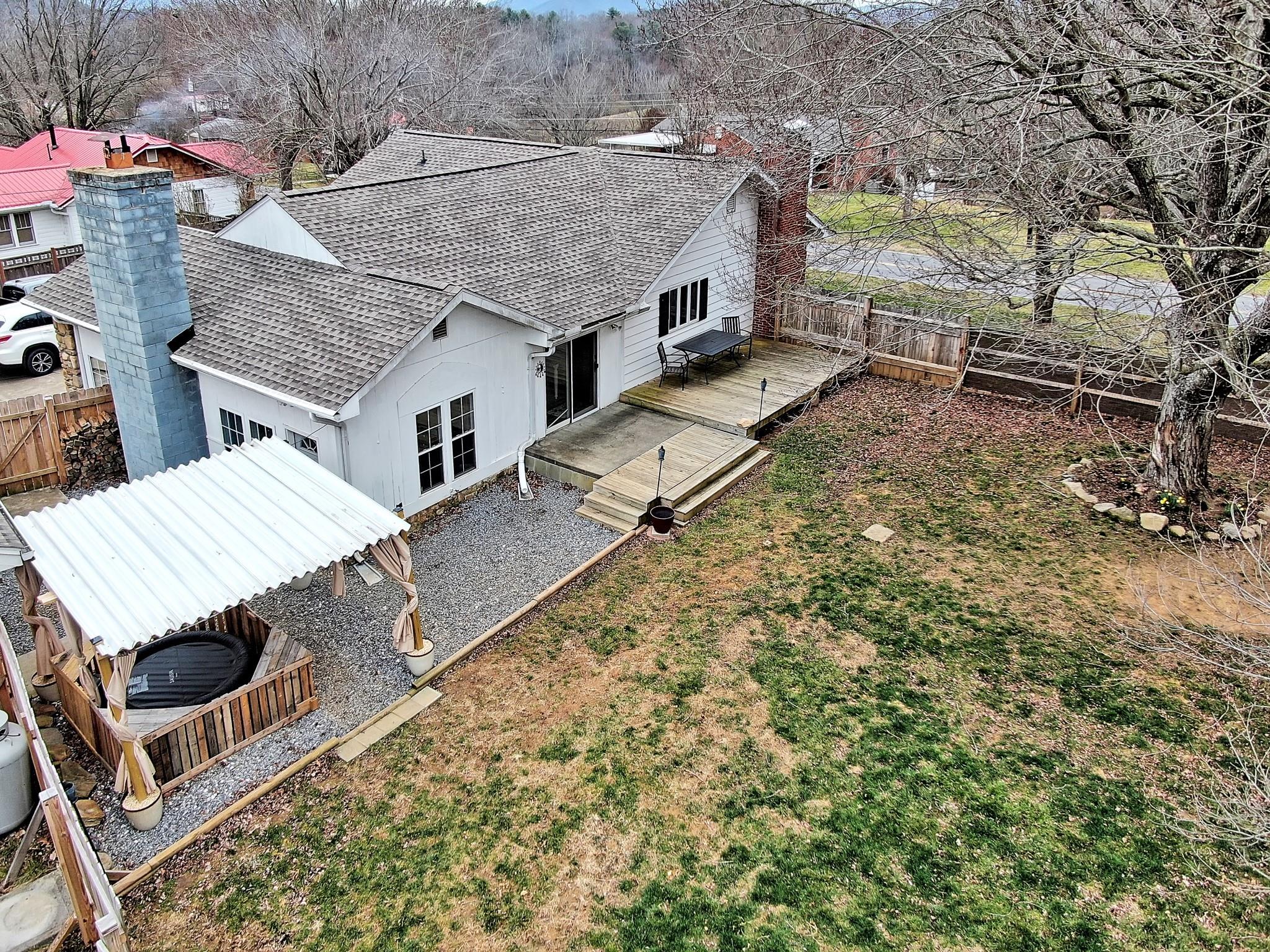670 Thompson Cove Road Clyde, NC 28721 - Photo 42 of 45 an aerial view of a house with swimming pool and wooden fence