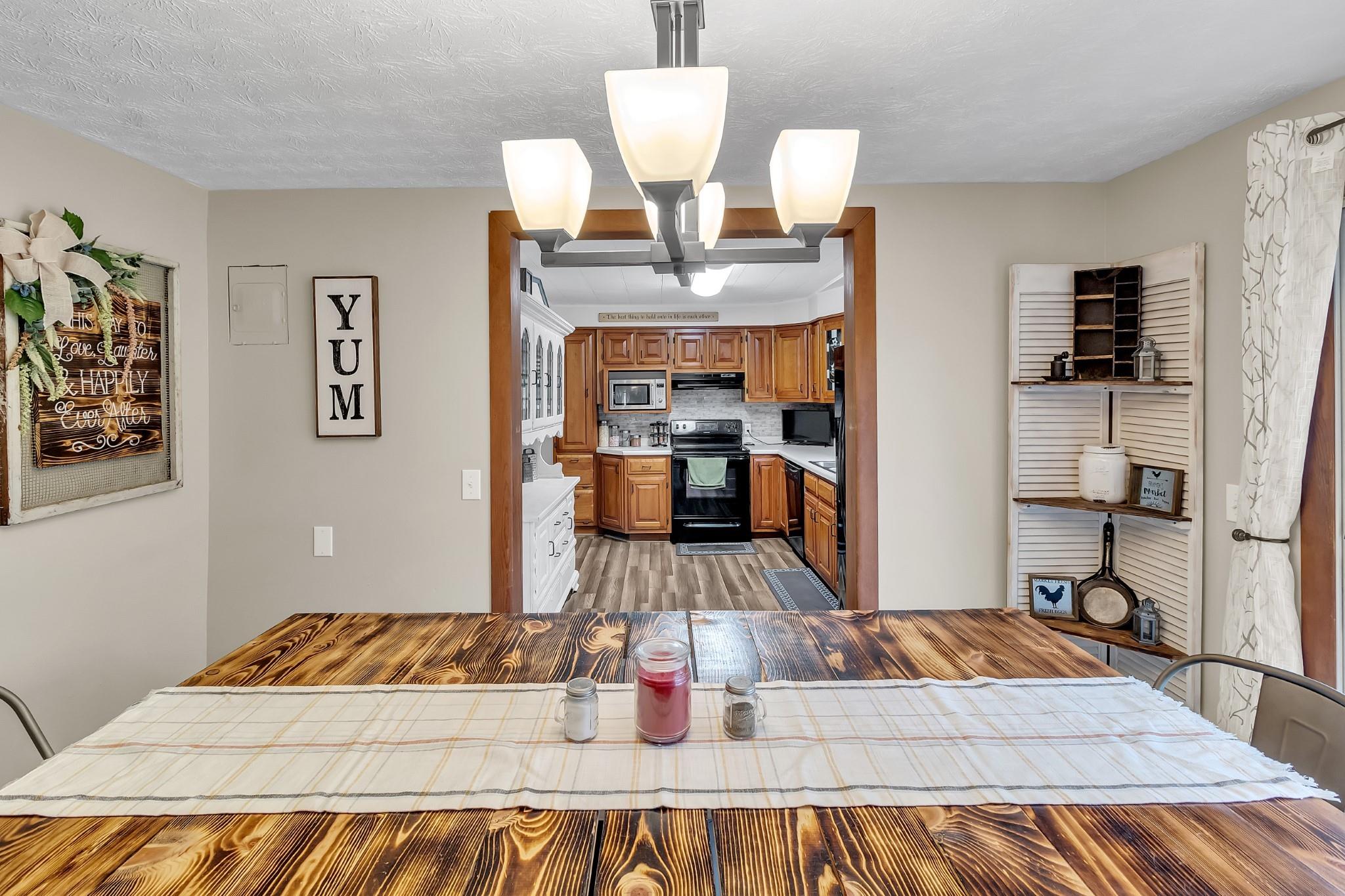 670 Thompson Cove Road Clyde, NC 28721 - Photo 6 of 45 a living room with dining room and wooden floor