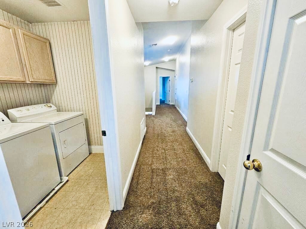 5953 Crumbling Ridge Street Henderson, NV 89011 - Photo 23 of 42 Functional laundry nook provides convenient access to a long, carpeted hallway.