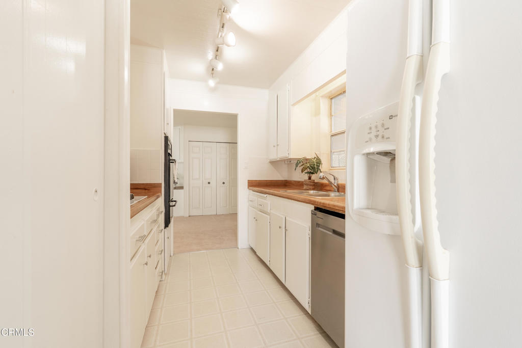 1202 Loma Drive, Unit 42 Ojai, CA 93023 - Photo 12 of 28 a large white kitchen with a sink and refrigerator