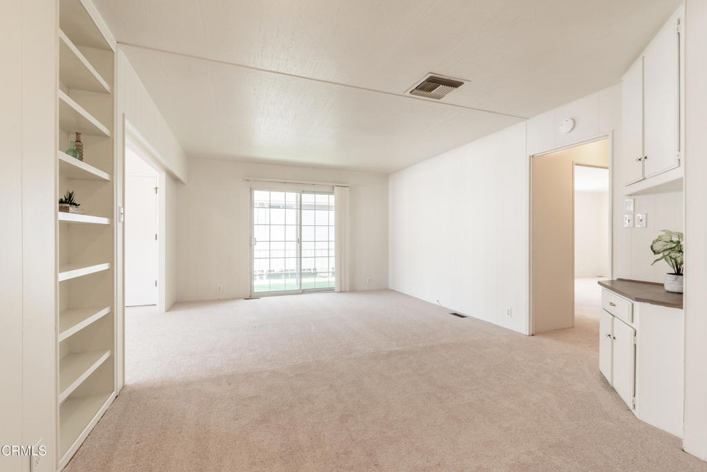 1202 Loma Drive, Unit 42 Ojai, CA 93023 - Photo 15 of 28 a view of an empty room with a window and kitchen view