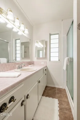 a bedroom with a large bed and a potted plant
