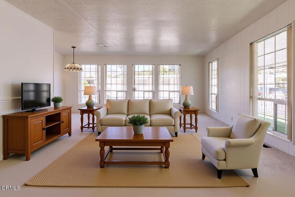 1202 Loma Drive, Unit 42 Ojai, CA 93023 - Photo 6 of 28 a living room with furniture a flat screen tv and a large window