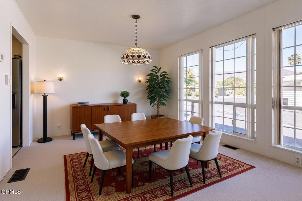 1202 Loma Drive, Unit 42 Ojai, CA 93023 - Photo 9 of 28 a view of a dining room with furniture window and wooden floor