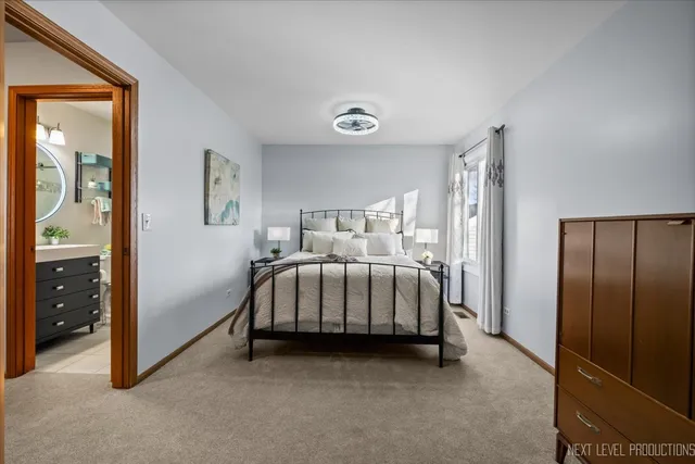 a bedroom with a bed and a night stand