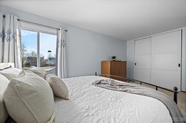 a bedroom with a bed and window