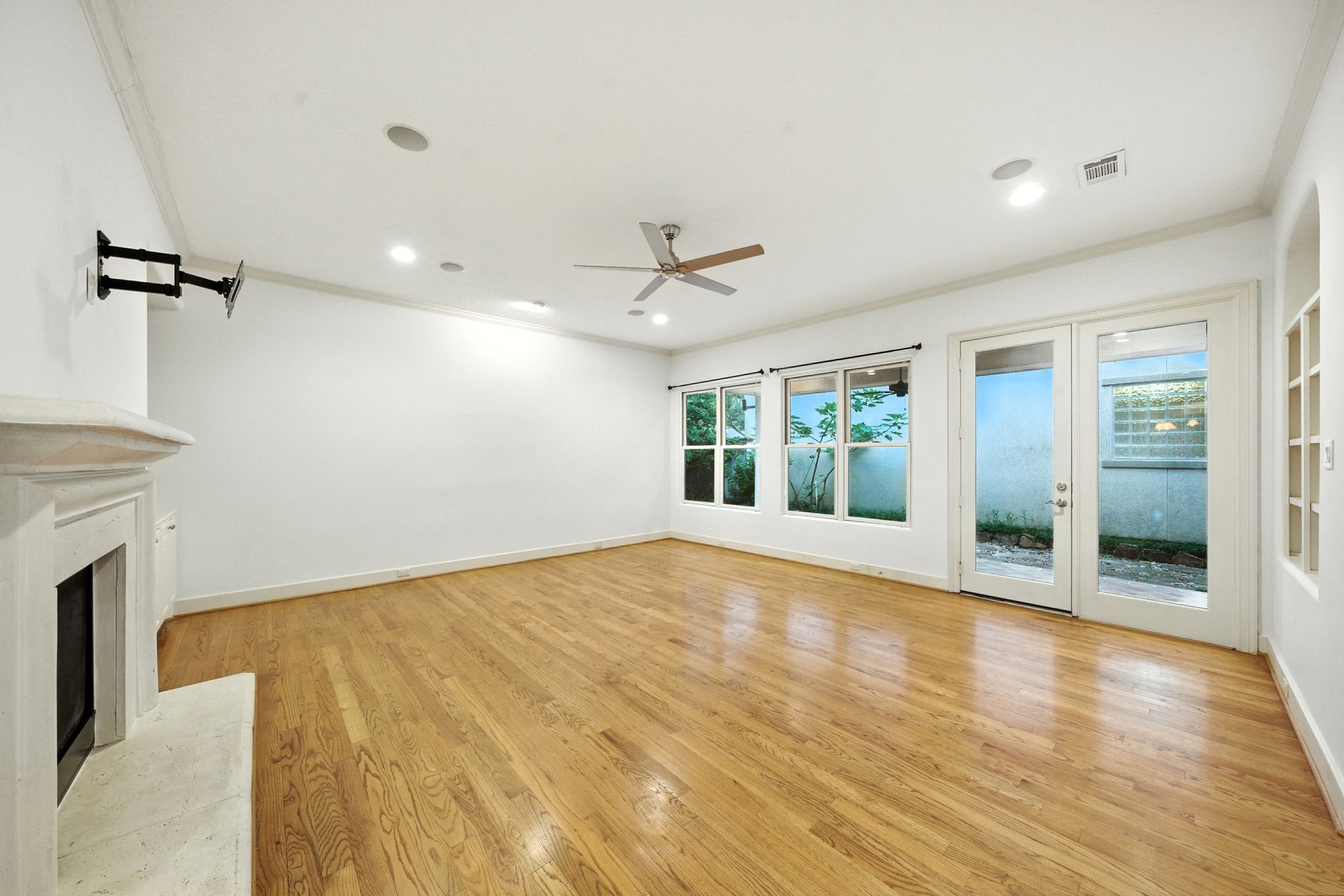 2714 Stuart Manor Houston, TX 77082 - Photo 14 of 49 Natural light streams through French doors that open to the backyard, creating a seamless connection between indoor and outdoor living. The open design allows this room to adapt effortlessly for both everyday relaxation and gatherings with family or friends.