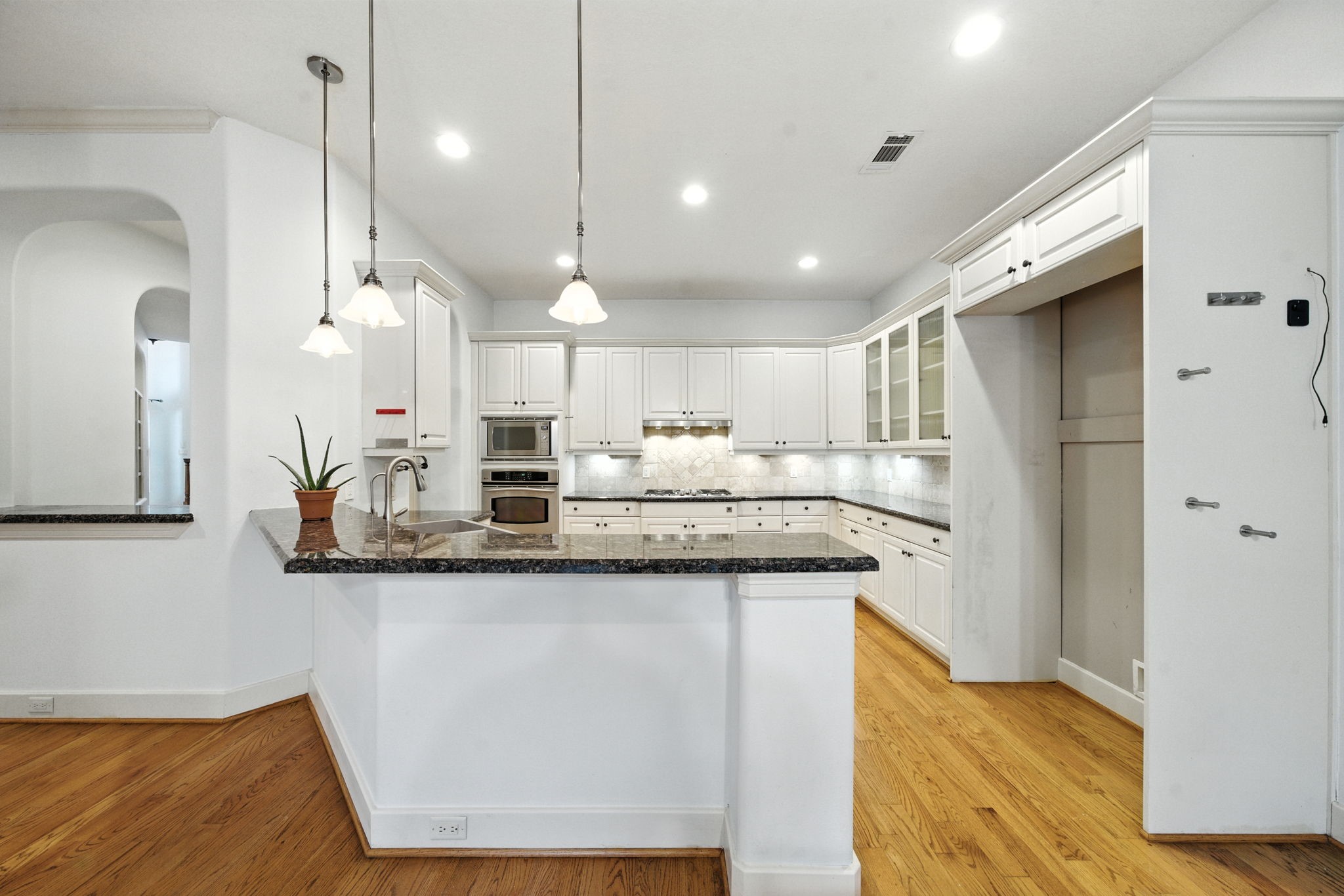 2714 Stuart Manor Houston, TX 77082 - Photo 17 of 49 An open-concept design keeps the kitchen connected to the breakfast and living areas, making it ideal for both entertaining and everyday living. Bright recessed lighting and clean sightlines create a spacious, welcoming feel throughout the main level.