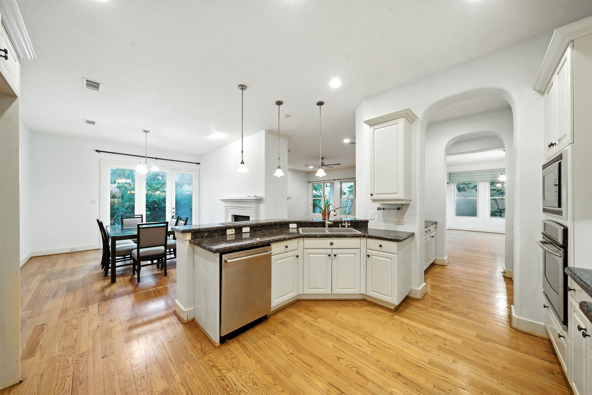 2714 Stuart Manor Houston, TX 77082 - Photo 21 of 49 Another view of the kitchen showcases its thoughtful layout, with ample cabinets, recessed lighting, and space for both cooking and gathering. This is a true heart-of-the-home space ready for your personal touch.