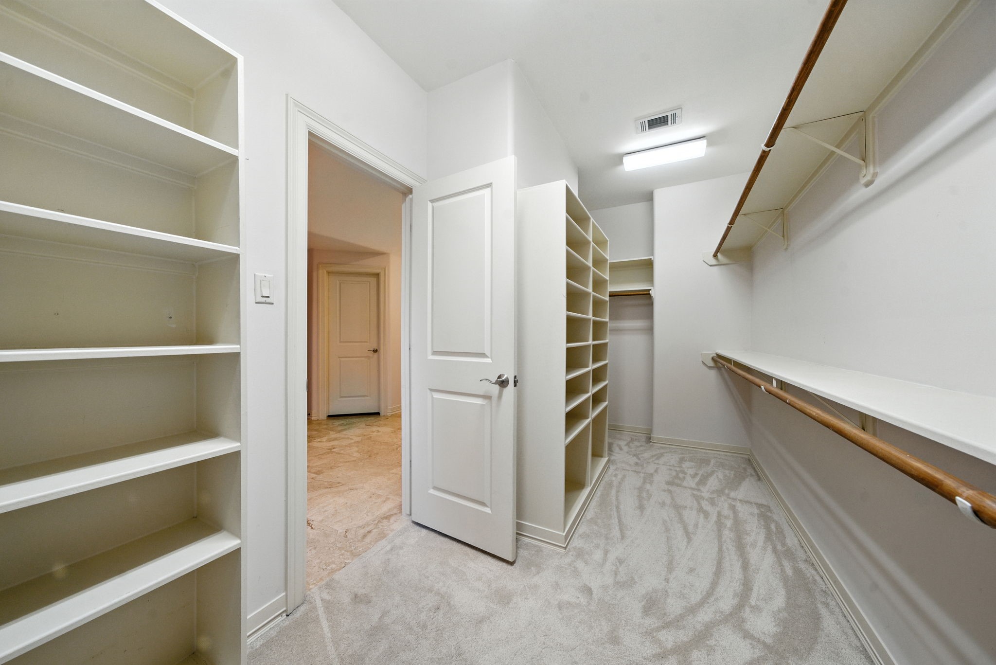 2714 Stuart Manor Houston, TX 77082 - Photo 31 of 49 The oversized walk-in closet offers exceptional storage with built-in shelving, ample hanging space, and plush carpeting—making organization effortless.