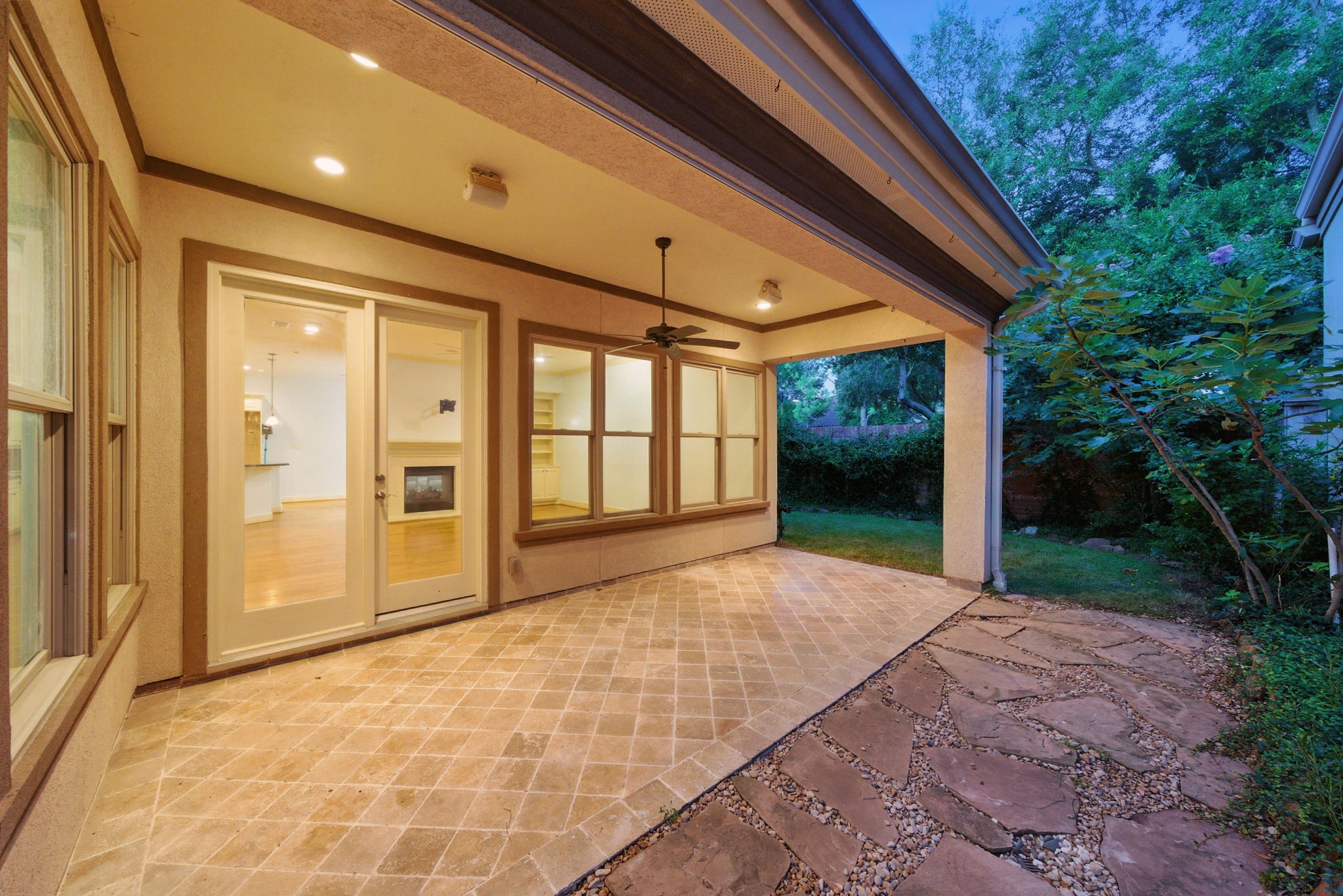 2714 Stuart Manor Houston, TX 77082 - Photo 43 of 49 A spacious covered patio extends the living space outdoors, complete with a ceiling fan, recessed lighting, and durable tile flooring—ideal for year-round enjoyment.