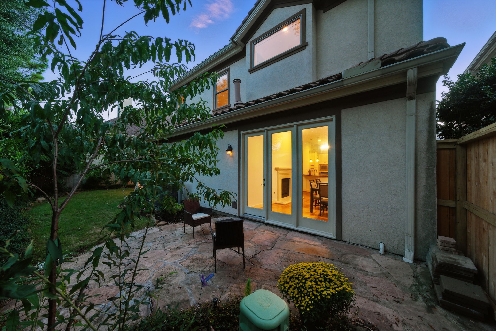 2714 Stuart Manor Houston, TX 77082 - Photo 44 of 49 Natural stone walkways lead you through the private yard, where lush greenery and mature trees create a tranquil escape. With multiple seating areas, this space easily accommodates gatherings or quiet moments surrounded by nature.