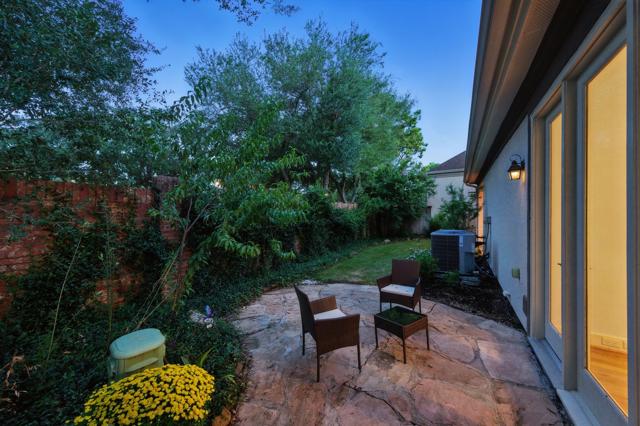 2714 Stuart Manor Houston, TX 77082 - Photo 45 of 49 Tucked beneath mature trees and privacy fencing, the flagstone patio creates an intimate retreat perfect for casual seating or evening gatherings.