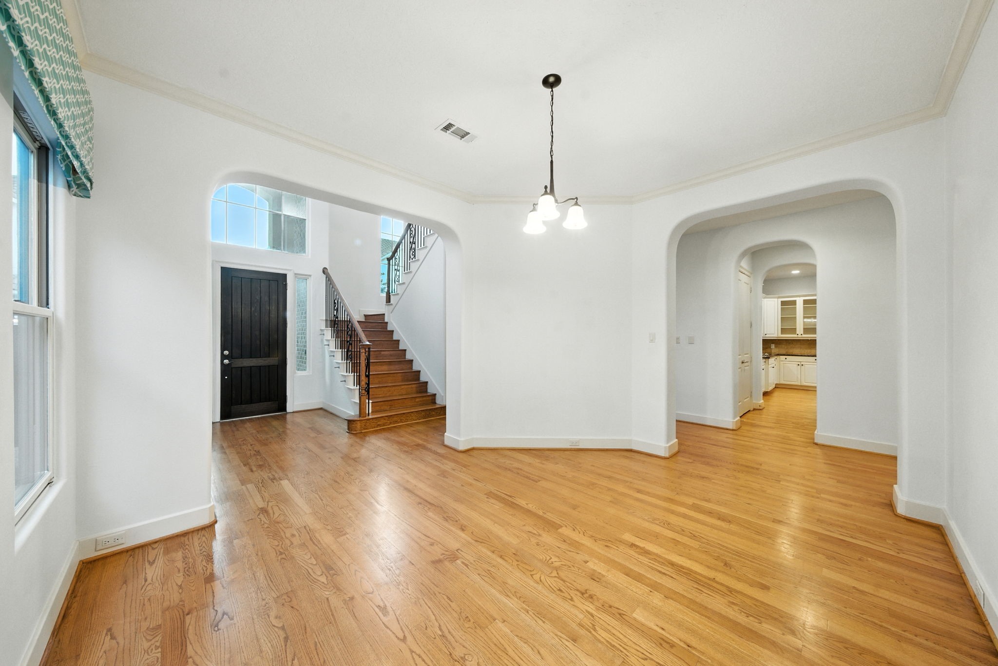 2714 Stuart Manor Houston, TX 77082 - Photo 6 of 49 The formal dining room offers a refined setting with tall windows, hardwood flooring, and graceful archways that connect beautifully to the main living areas—perfect for hosting dinners and celebrations.