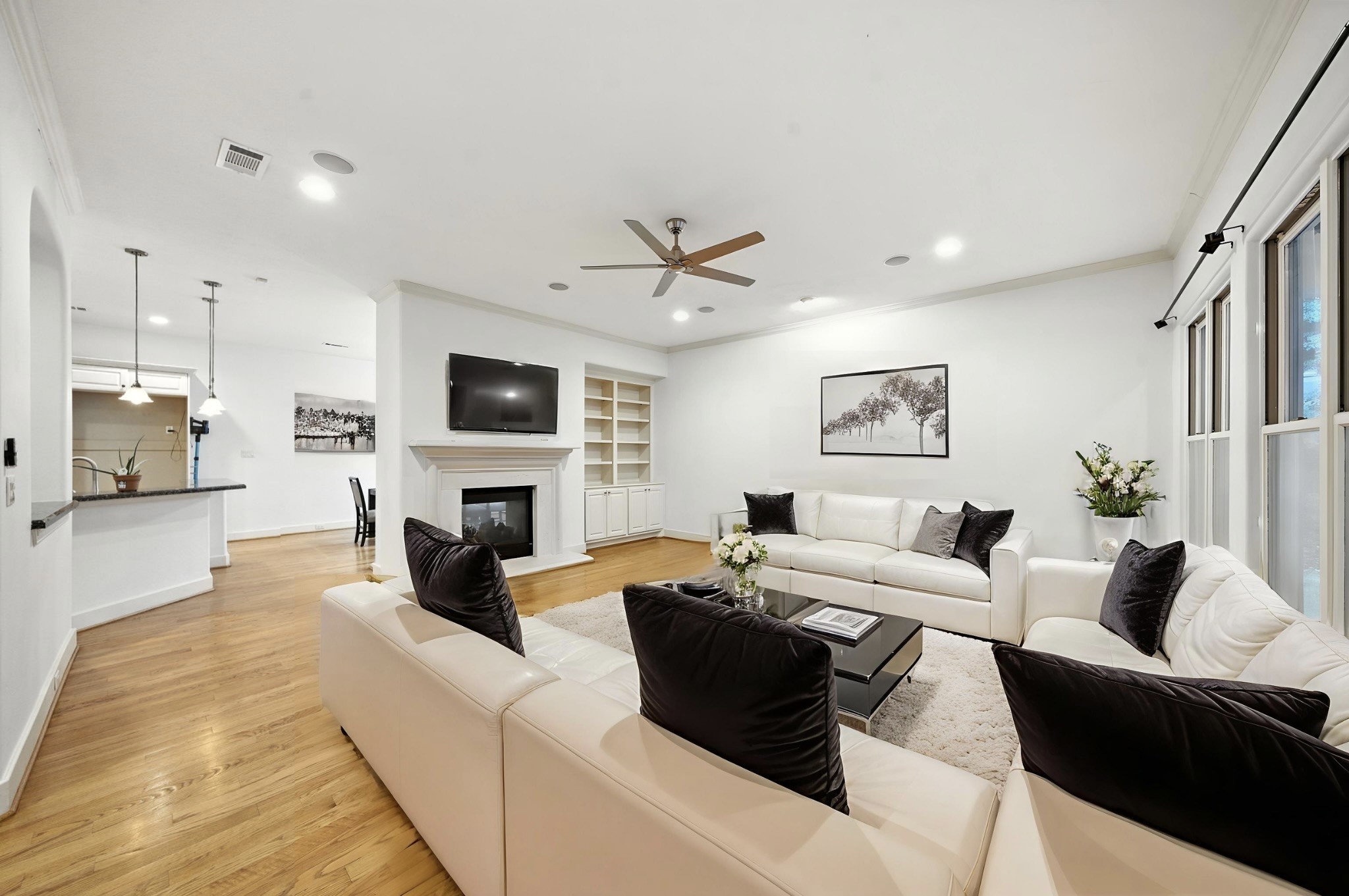 2714 Stuart Manor Houston, TX 77082 - Photo 9 of 49 Image is Virtually Staged - This inviting living room welcomes you with gleaming hardwood floors, tall windows, and a bright, open layout designed for both comfort and entertaining. The space flows naturally into the kitchen and dining areas, making it the true centerpiece of the home.