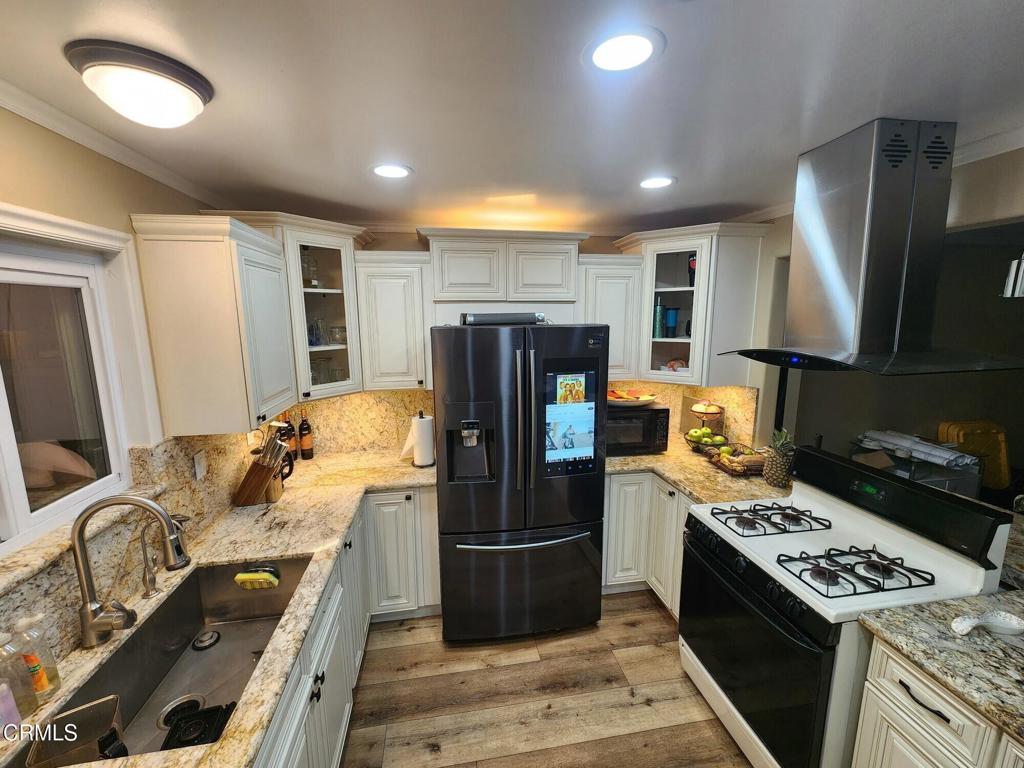 1440 Morris Street Oxnard, CA 93030 - Photo 2 of 7 a kitchen with refrigerator stove and oven