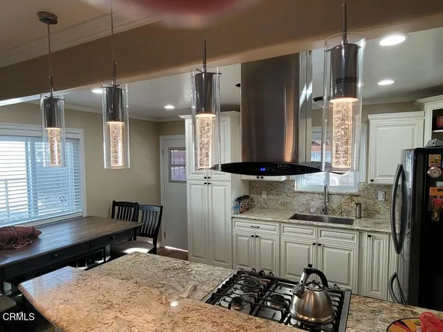 a kitchen with sink refrigerator and stove
