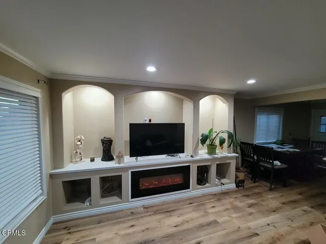 a living room with furniture flat screen tv and fireplace
