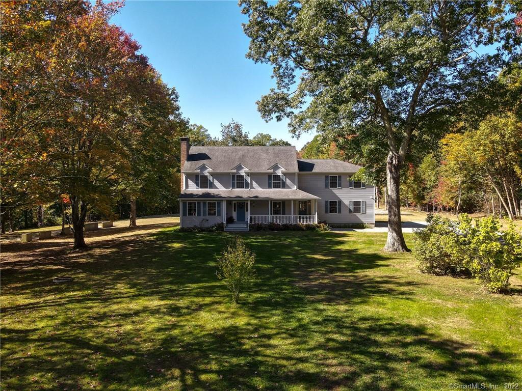 Set far from road, an elegant dormered Colonial has 3,010 sq ft and 5 bedrooms.