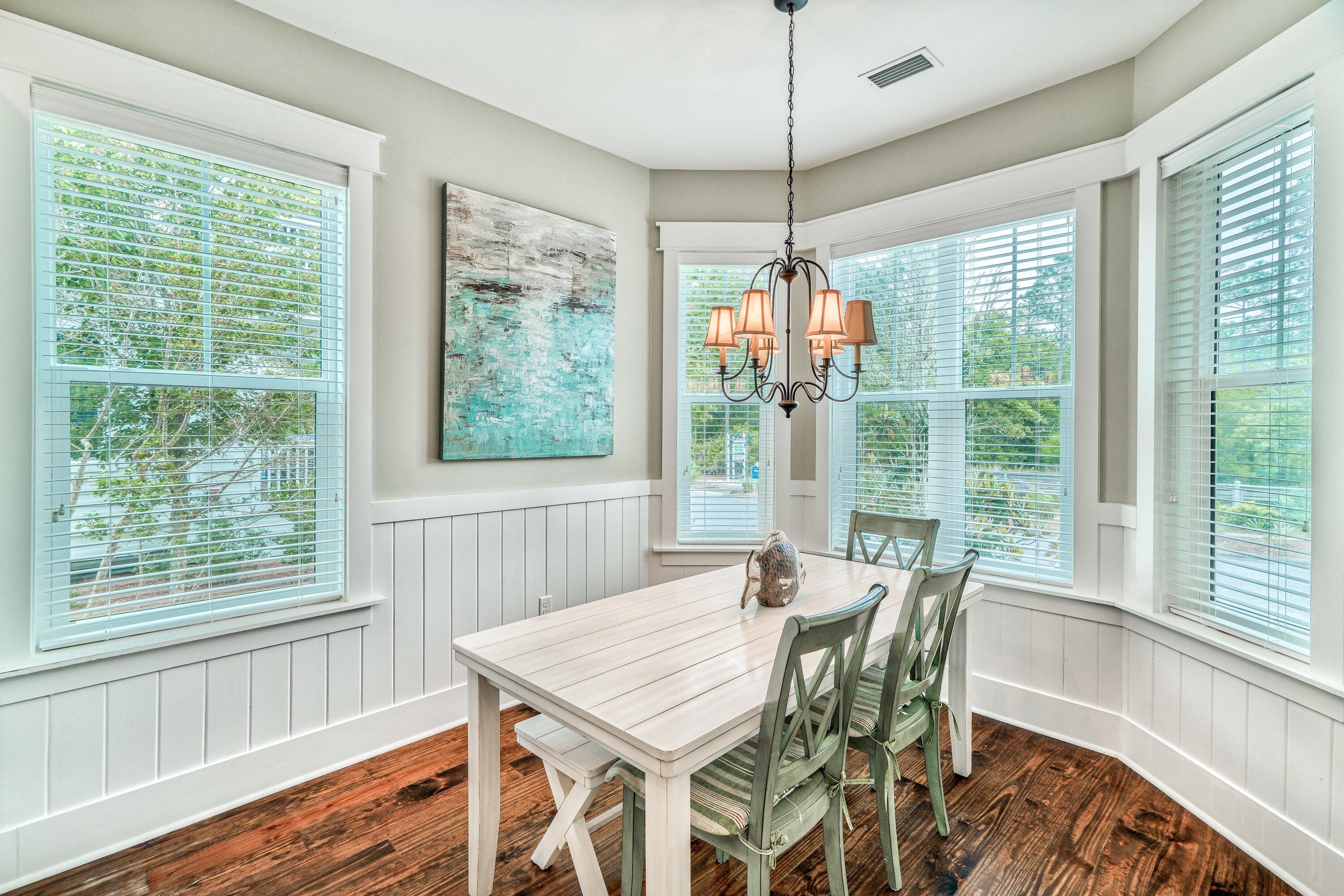 985 Sandgrass Boulevard Santa Rosa Beach, FL 32459 - Photo 13 of 65 a view of a dining room with furniture window and wooden floor