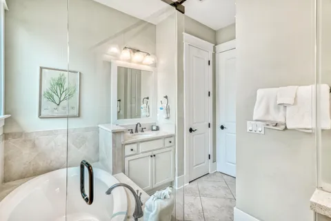 a spacious bathroom with a granite countertop sink a toilet and a mirror