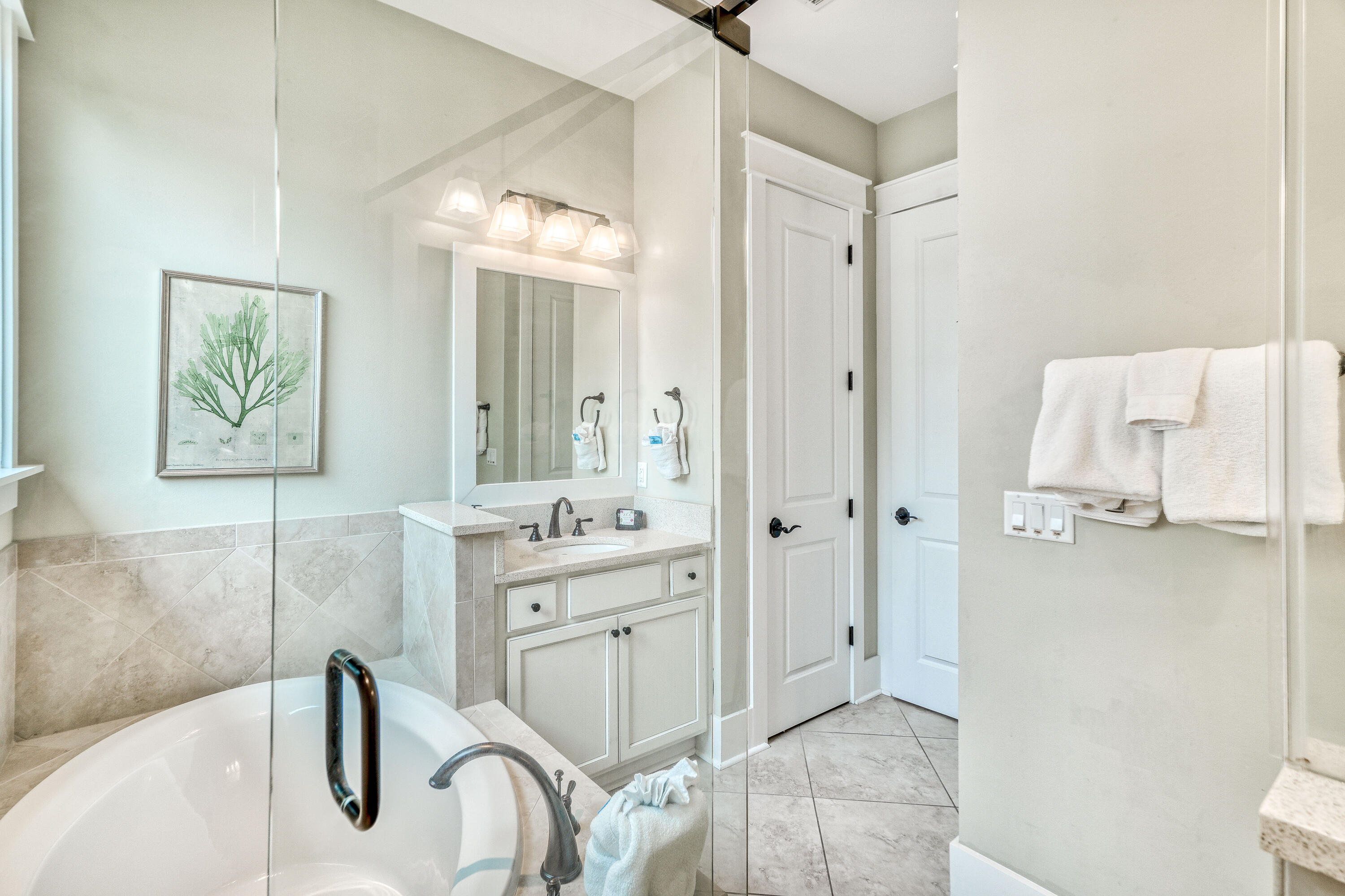 985 Sandgrass Boulevard Santa Rosa Beach, FL 32459 - Photo 21 of 65 a spacious bathroom with a granite countertop sink a toilet and a mirror