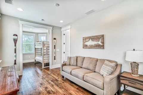 a living room with furniture and a wooden floor