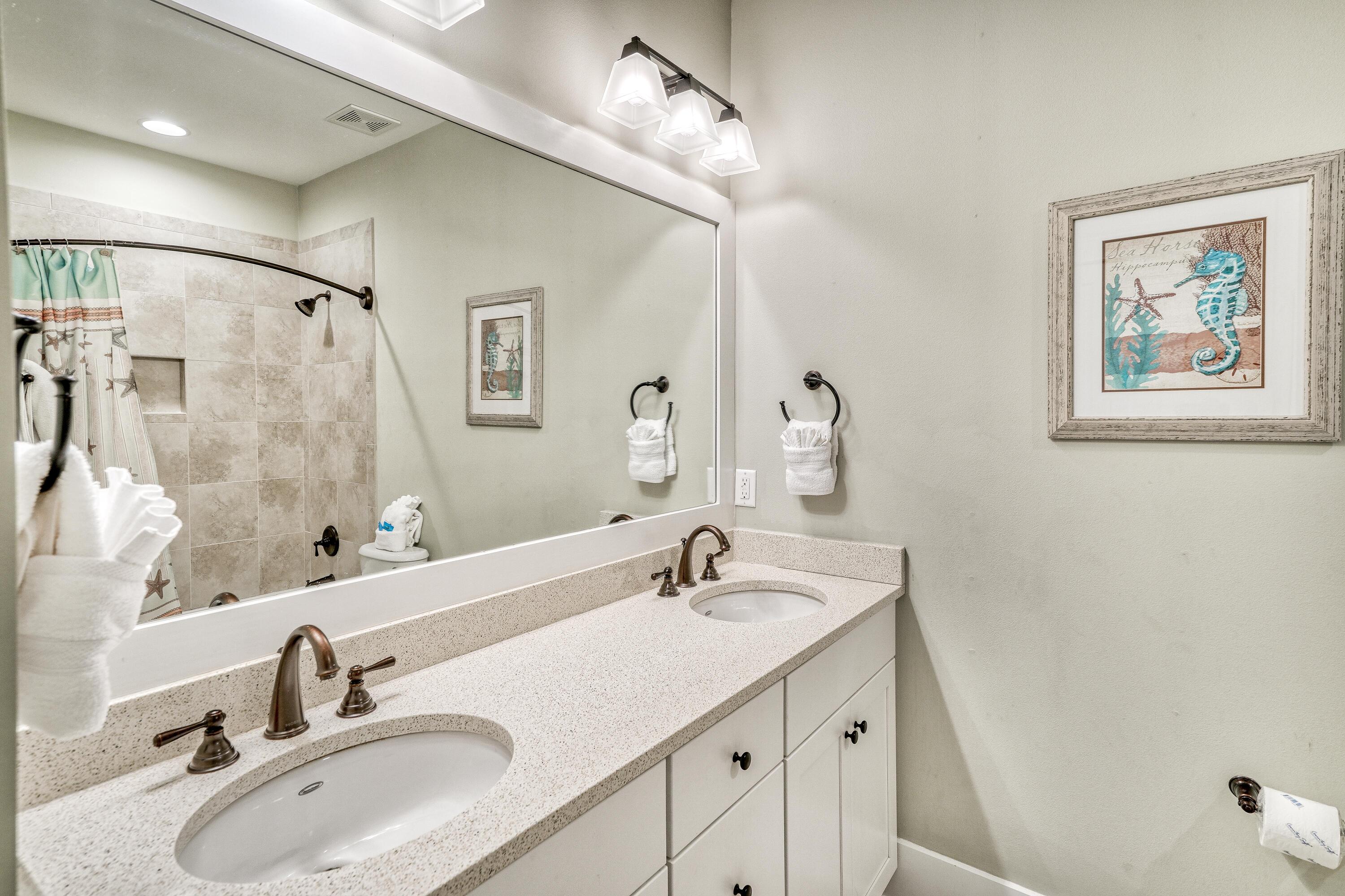985 Sandgrass Boulevard Santa Rosa Beach, FL 32459 - Photo 39 of 65 a bathroom with a sink and a mirror