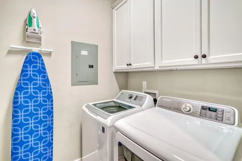 a view of a patio with a table and chairs and floor to ceiling window