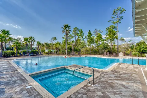 a view of a house with sitting area and swimming pool