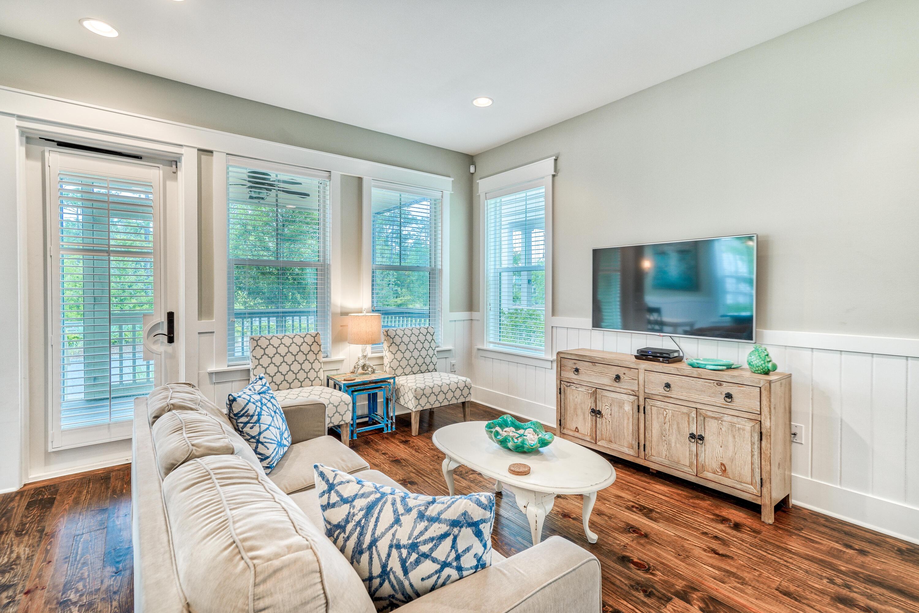 985 Sandgrass Boulevard Santa Rosa Beach, FL 32459 - Photo 5 of 65 a living room with furniture and a flat screen tv