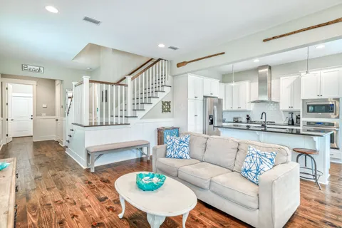 a living room with furniture and kitchen view
