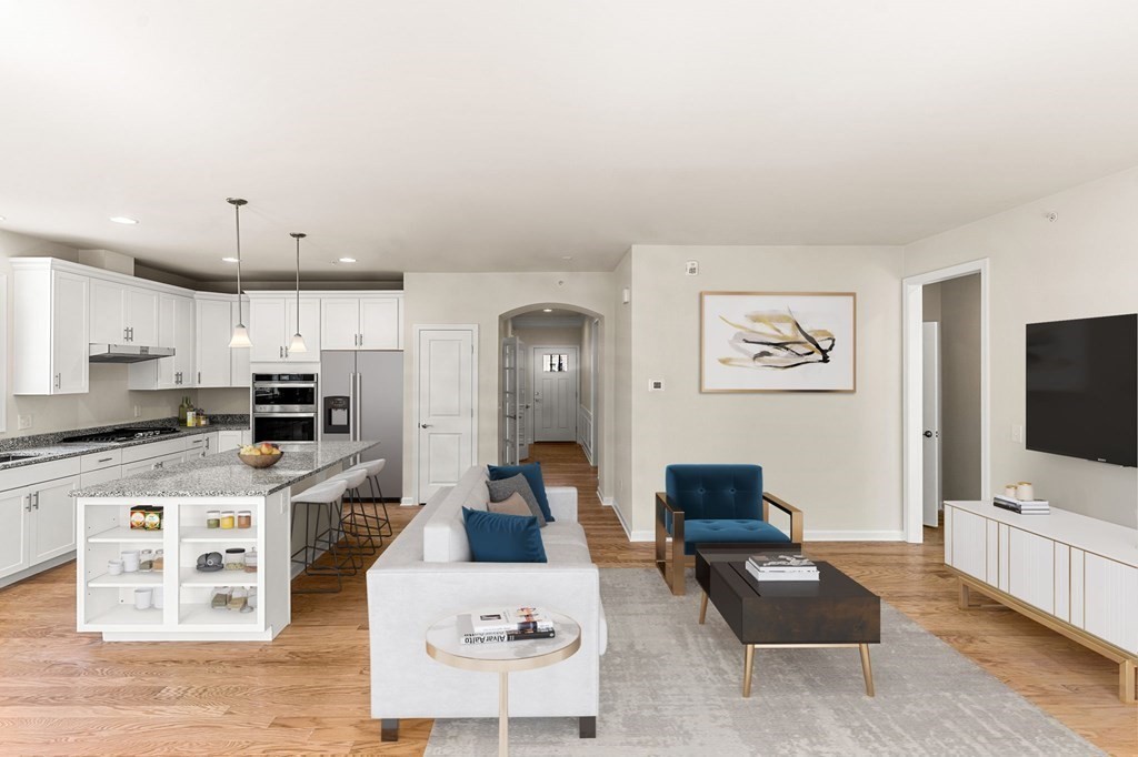 57 Sienna Circle, Unit 44 Upton, MA 01568 - Photo 11 of 21 a living room with furniture a flat screen tv and kitchen view