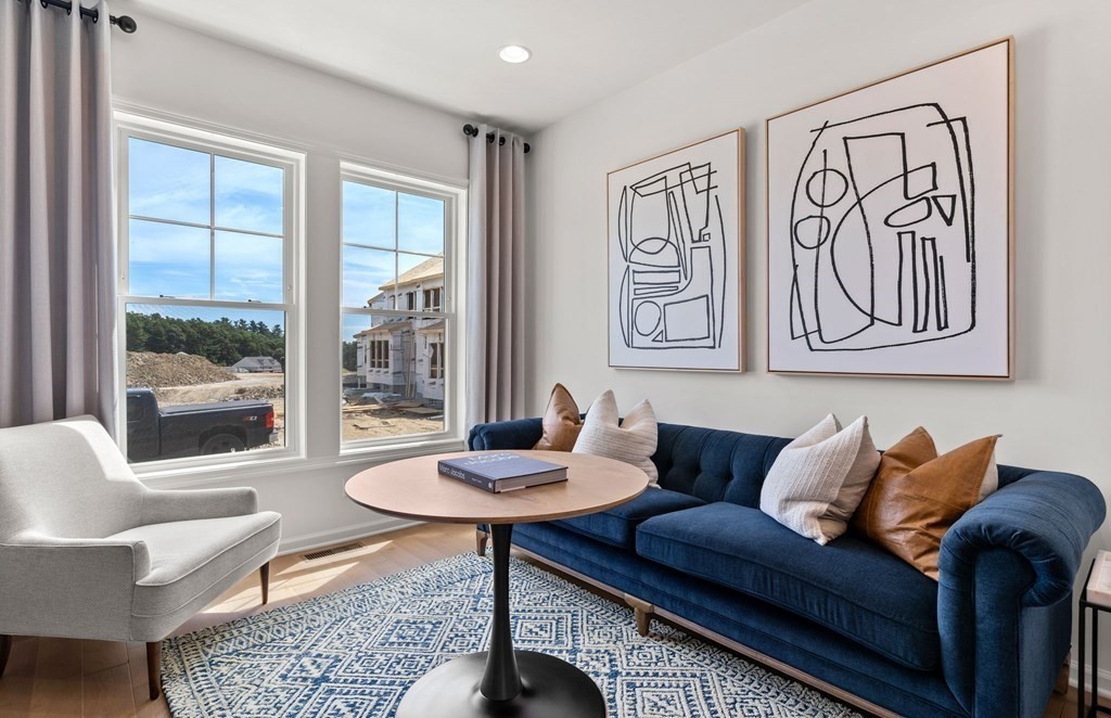 57 Sienna Circle, Unit 44 Upton, MA 01568 - Photo 14 of 21 a living room with furniture and a table