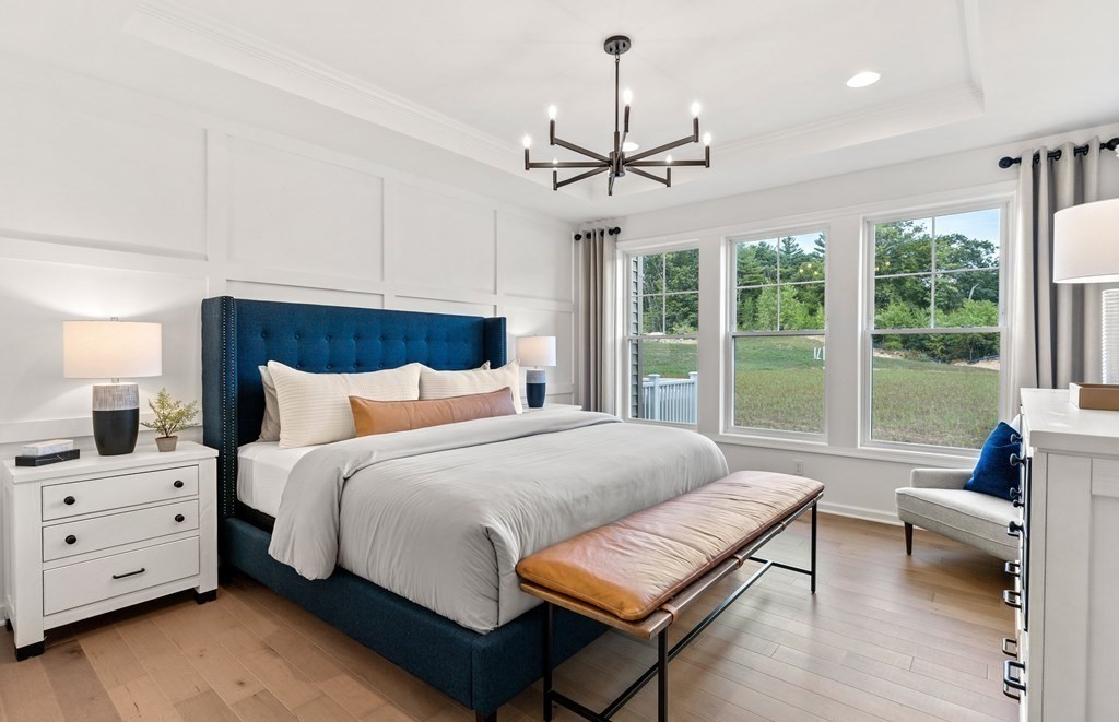 57 Sienna Circle, Unit 44 Upton, MA 01568 - Photo 15 of 21 a spacious bedroom with a bed a couch and a window