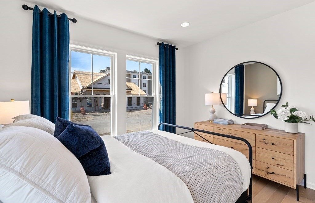 57 Sienna Circle, Unit 44 Upton, MA 01568 - Photo 18 of 21 a bedroom with a bed and a mirror