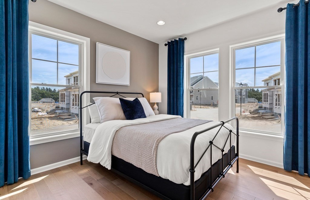 57 Sienna Circle, Unit 44 Upton, MA 01568 - Photo 19 of 21 a bedroom with a bed and large window