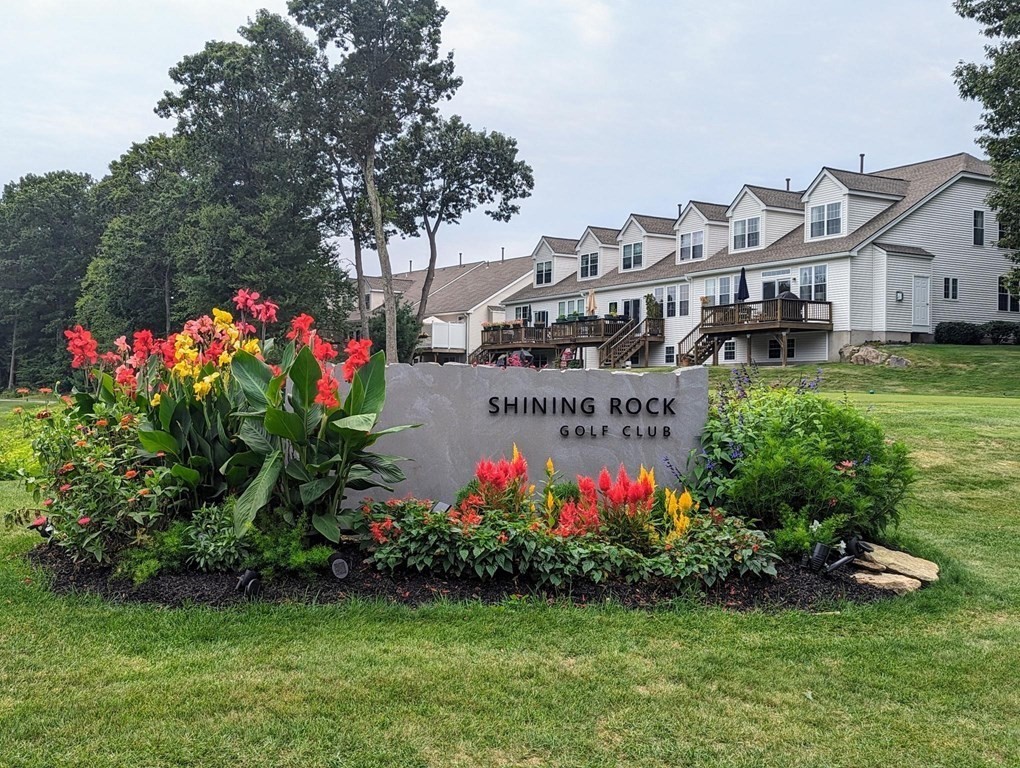 57 Sienna Circle, Unit 44 Upton, MA 01568 - Photo 20 of 21 a sign that is sitting in the grass next to a building