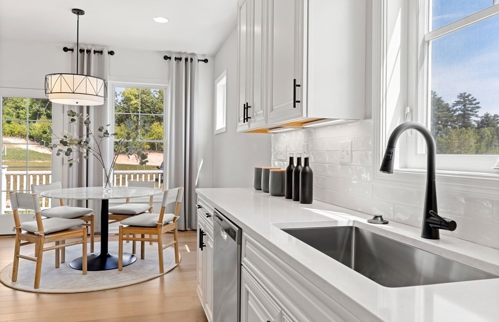 57 Sienna Circle, Unit 44 Upton, MA 01568 - Photo 6 of 21 a kitchen with stainless steel appliances granite countertop a sink a counter top space a granite counter tops and a view of living room